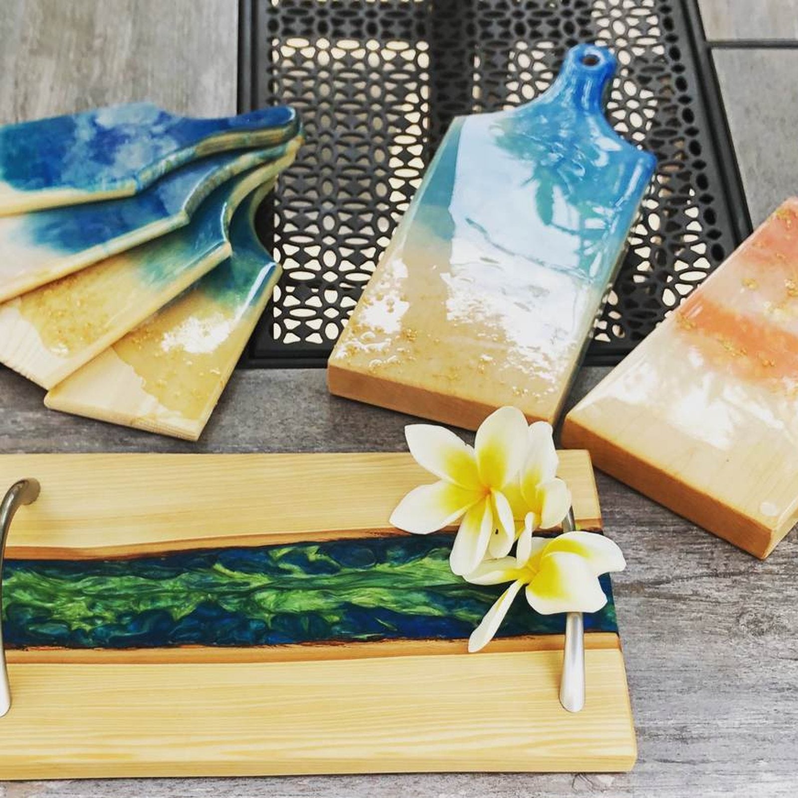 Hardwood serving boards with blue and sunset resin rivers
