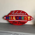 A layered wood sign reading Fabulous Hillcrest San Diego in red with multicolored letters