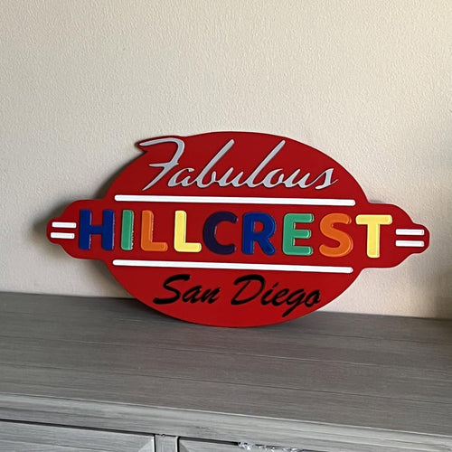 A layered wood sign reading Fabulous Hillcrest San Diego in red with multicolored letters