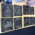 Slate coasters engraved with Navy, Army, Marines and Veteran emblems