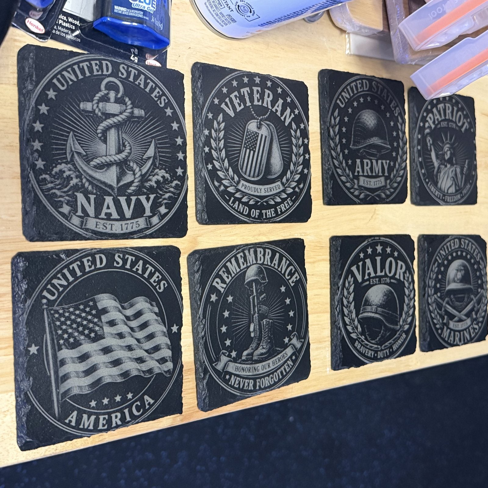 Slate coasters engraved with Navy, Army, Marines and Veteran emblems